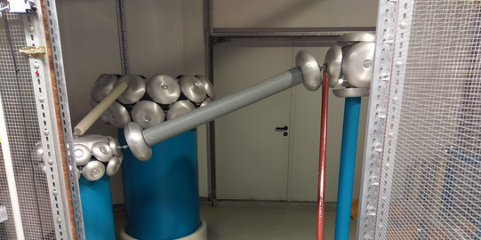 Test set-up in the high-voltage laboratory with 200 kV test transformer and voltage divider